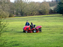 Student cutting grass